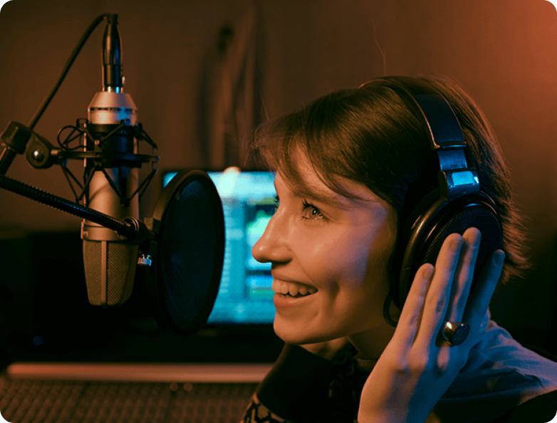 A radio host wearing headphones speaking into a studio microphone
